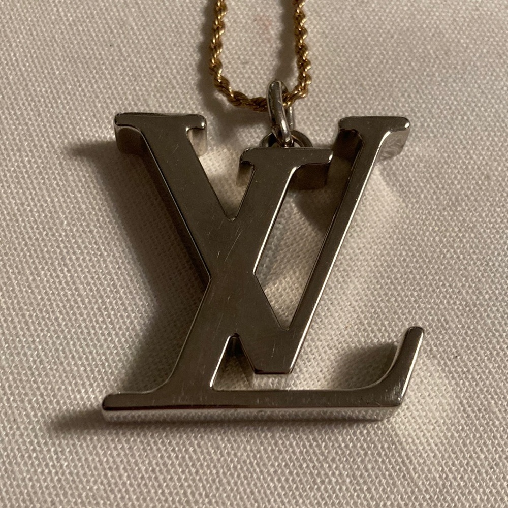 Louis Vuitton giant logo charm on a necklace in silver and gold